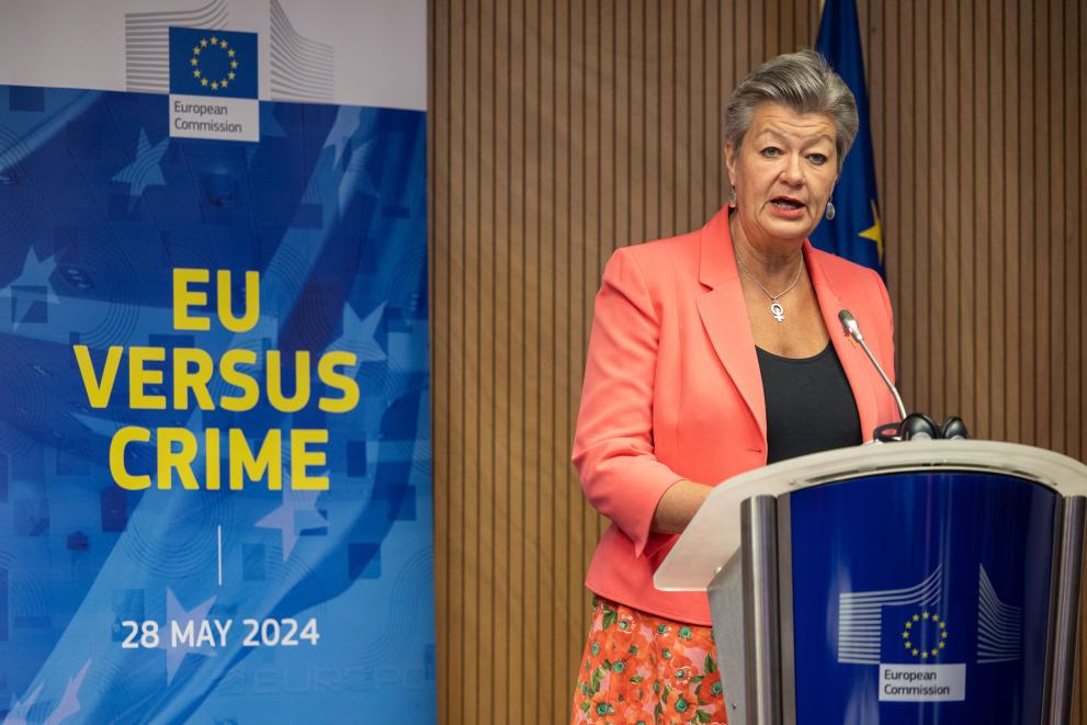 Commissioner for Home Affairs and Migration, Ylva Johansson, delivers her speech in front of a banner marked: EU VERSUS CRIME - 28 MAY 2024.