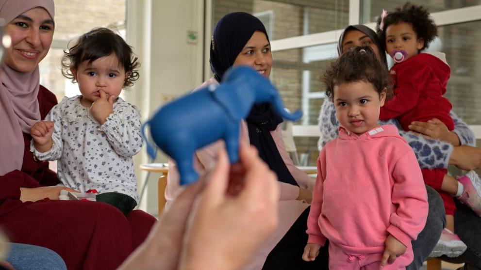 Mothers with their your=g children in a language course offered by the project.