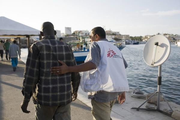 man accompanying migrant to safety 