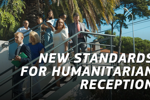Photo of a visit of the reception centre. The text reads: New standards for humanitarian reception